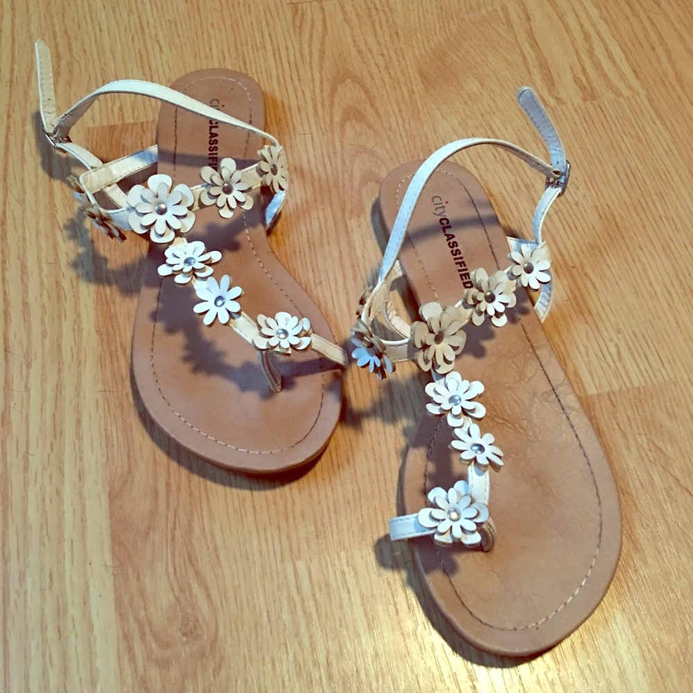 White sandals with floral design.